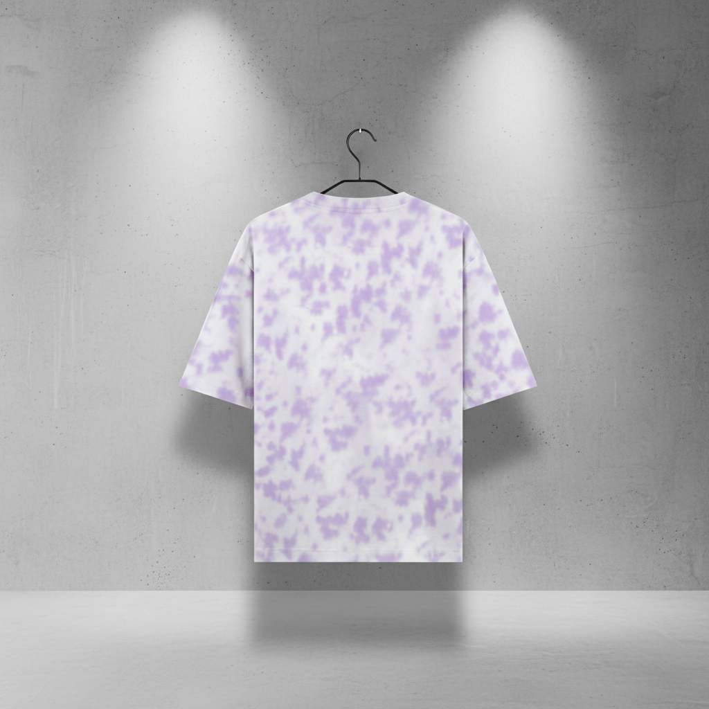 Purple and white patterned t-shirt on a hanger against a gray concrete wall.